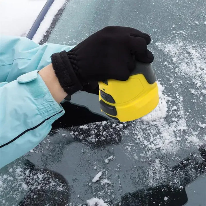 Gul elektrisk isskrapa på bilruta