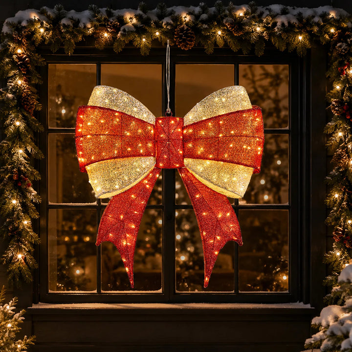 Stor belyst julrosett i rött och guld