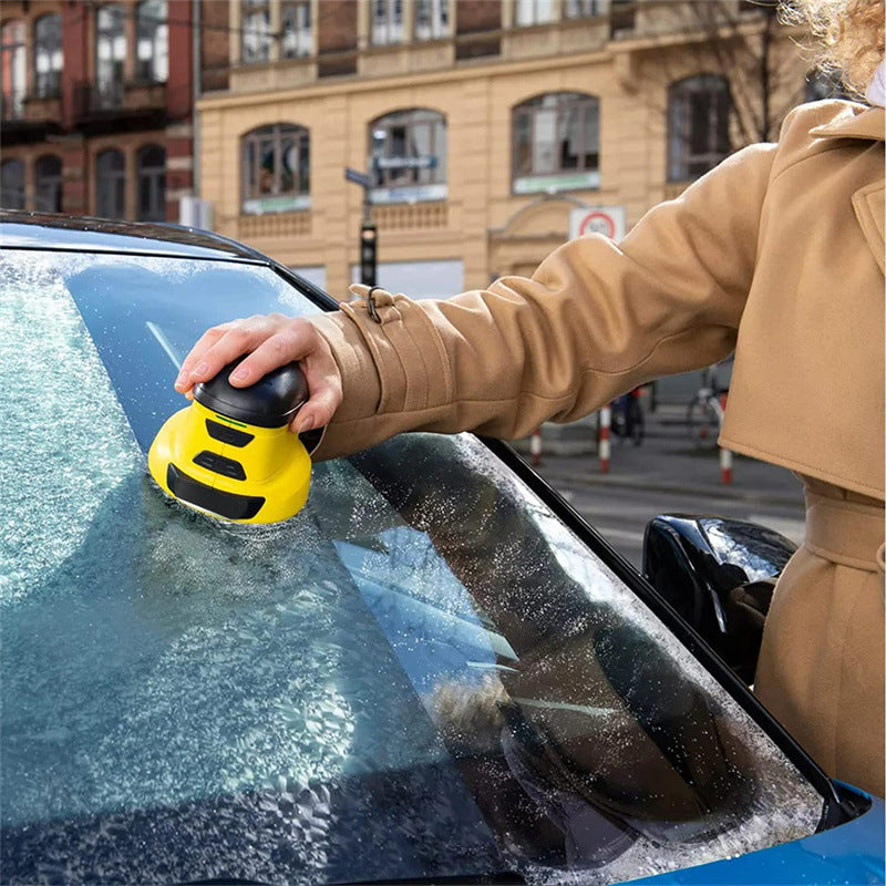 Gul elektrisk isskrapa på bilruta